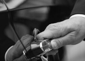 chauffeur standing by the open rear door