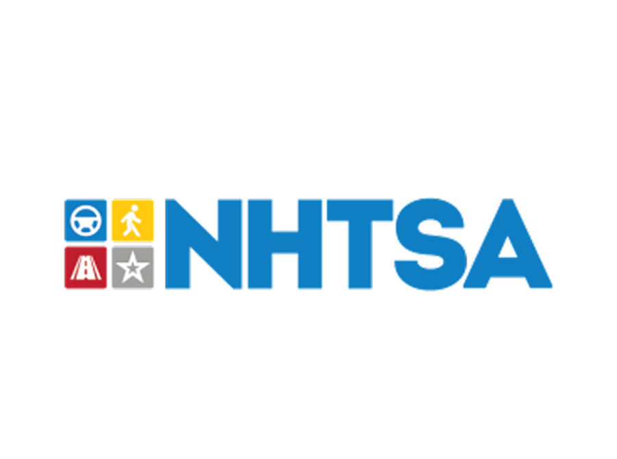 The NHTSA logo features the letters "NHTSA" in bold blue font beside four colored squares with icons: a blue steering wheel, a yellow pedestrian, a red highway, and a gray star, all on a white background.The image shows the NHTSA logo with the letters "NHTSA" in bold blue font next to four colored squares that contain icons: a blue steering wheel, a yellow pedestrian, a red road, and a gray star, all on a white background.